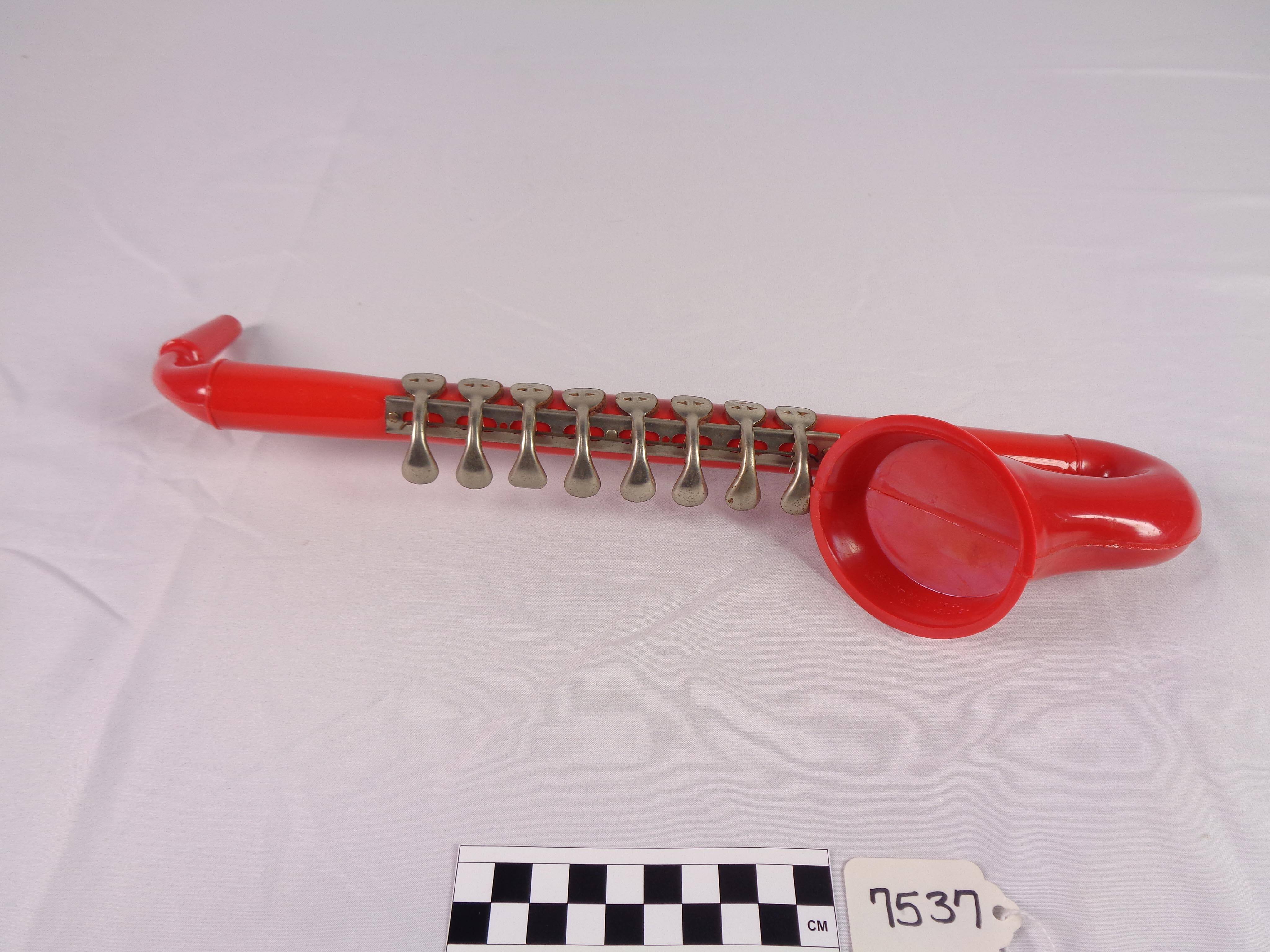Toy harmonica, saxophone-shaped